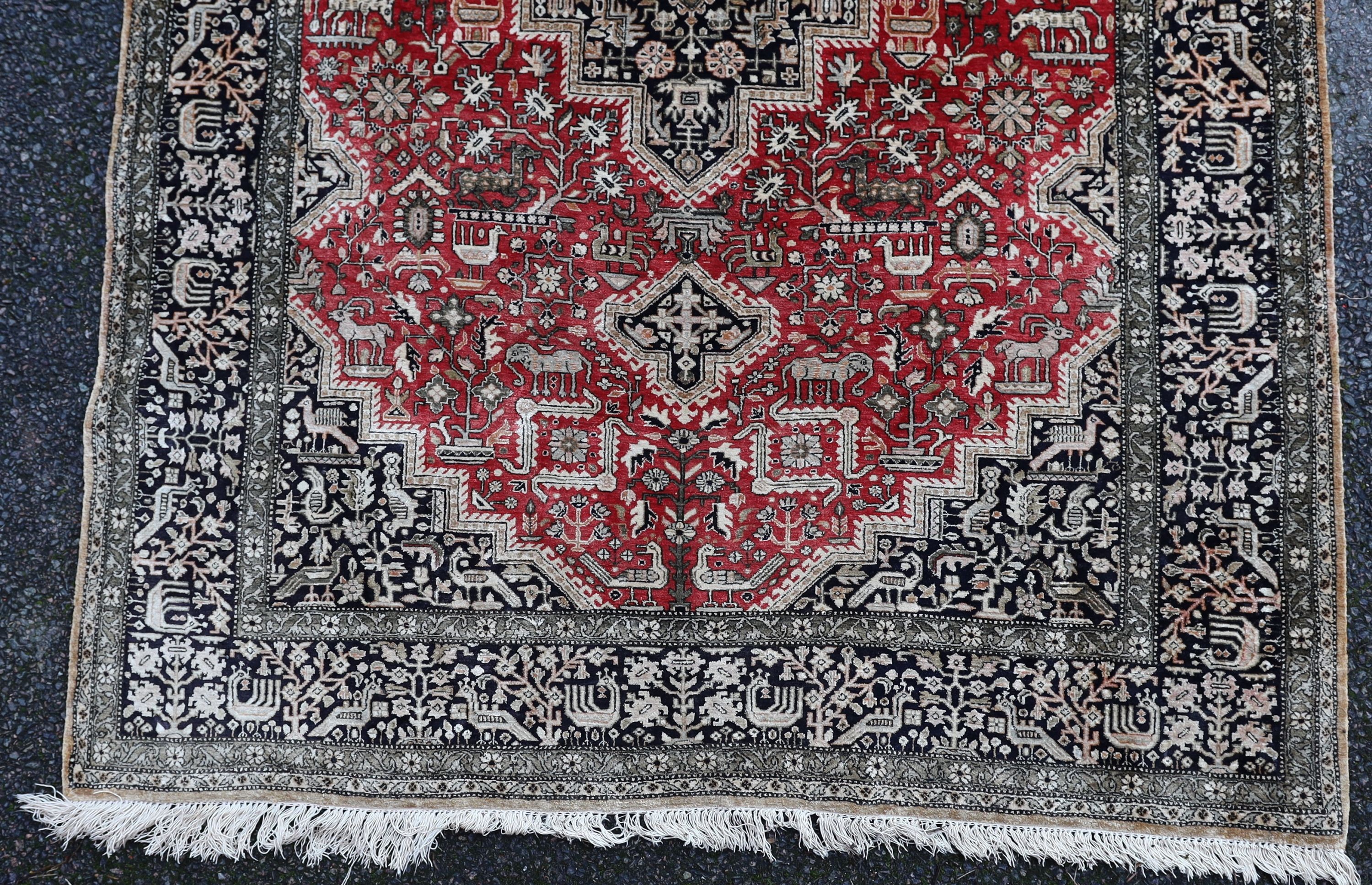 An early 20th century Caucasian silk red ground rug, 206 x 132cm.